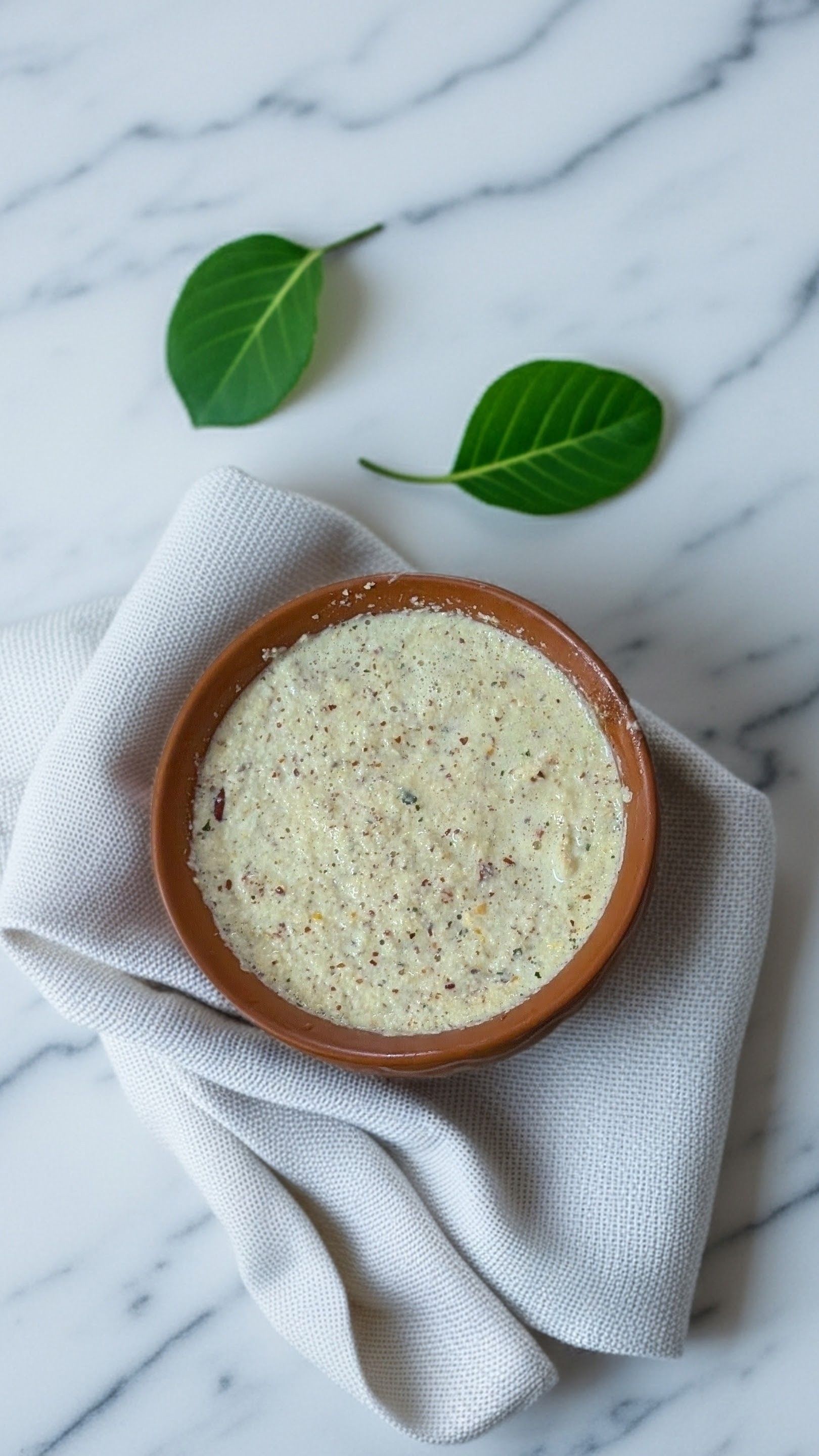 Creamy rice pudding studded with nuts served in a traditional clay bowl
