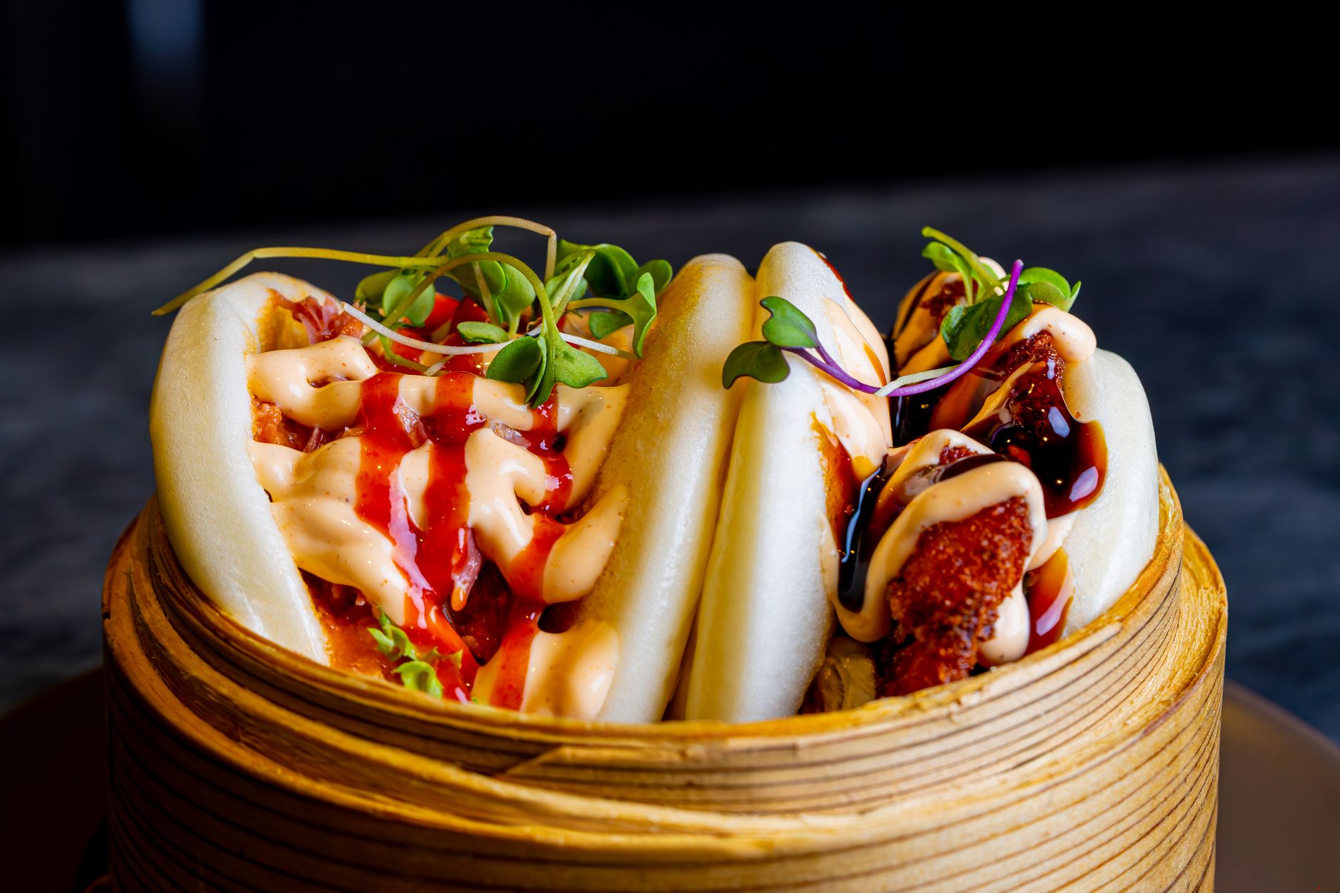 Pan-fried and steamed bao buns arranged on trays at a Soho counter