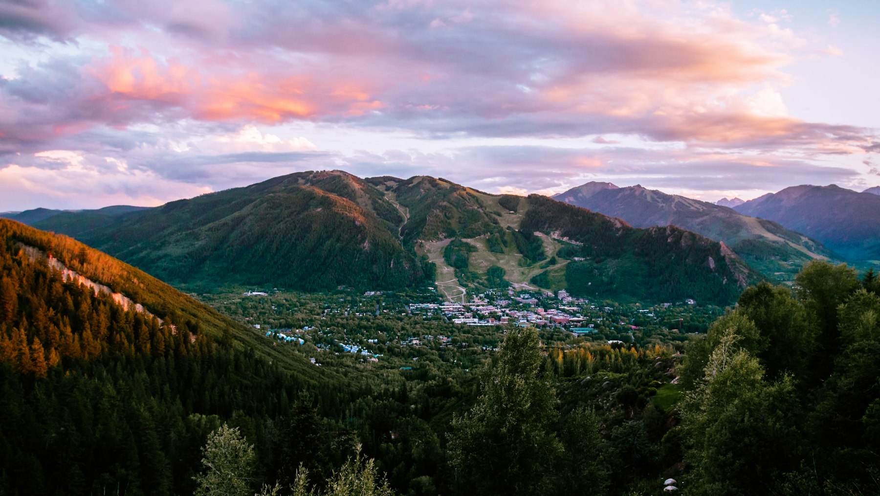 An Aspen, Colorado mountain town seen from above at sunset