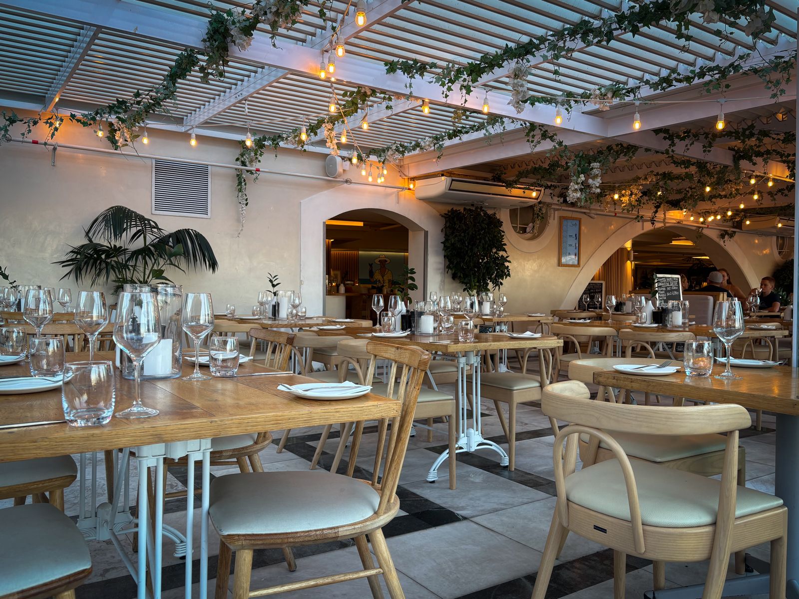 An elegant restaurant dining room set with wine glasses ahead of dinner service