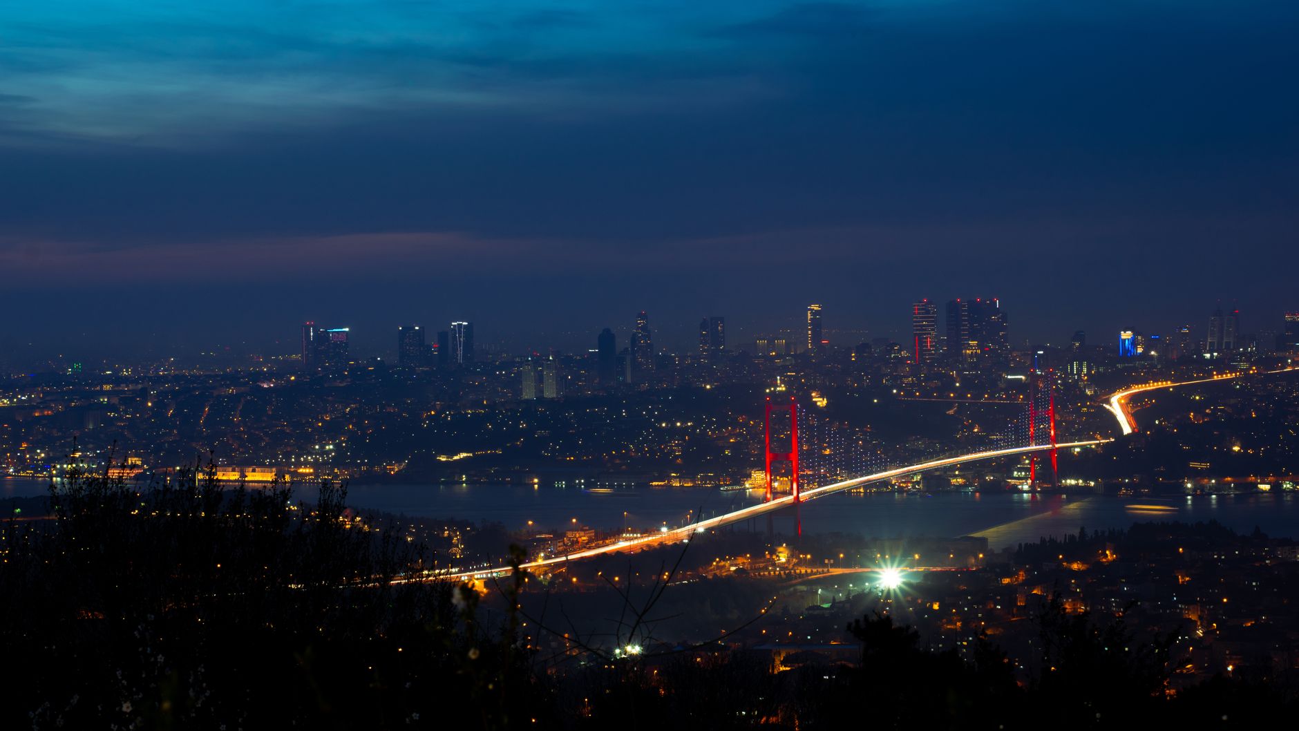 The illuminated Bosphorus Bridge and Istanbul skyline at night