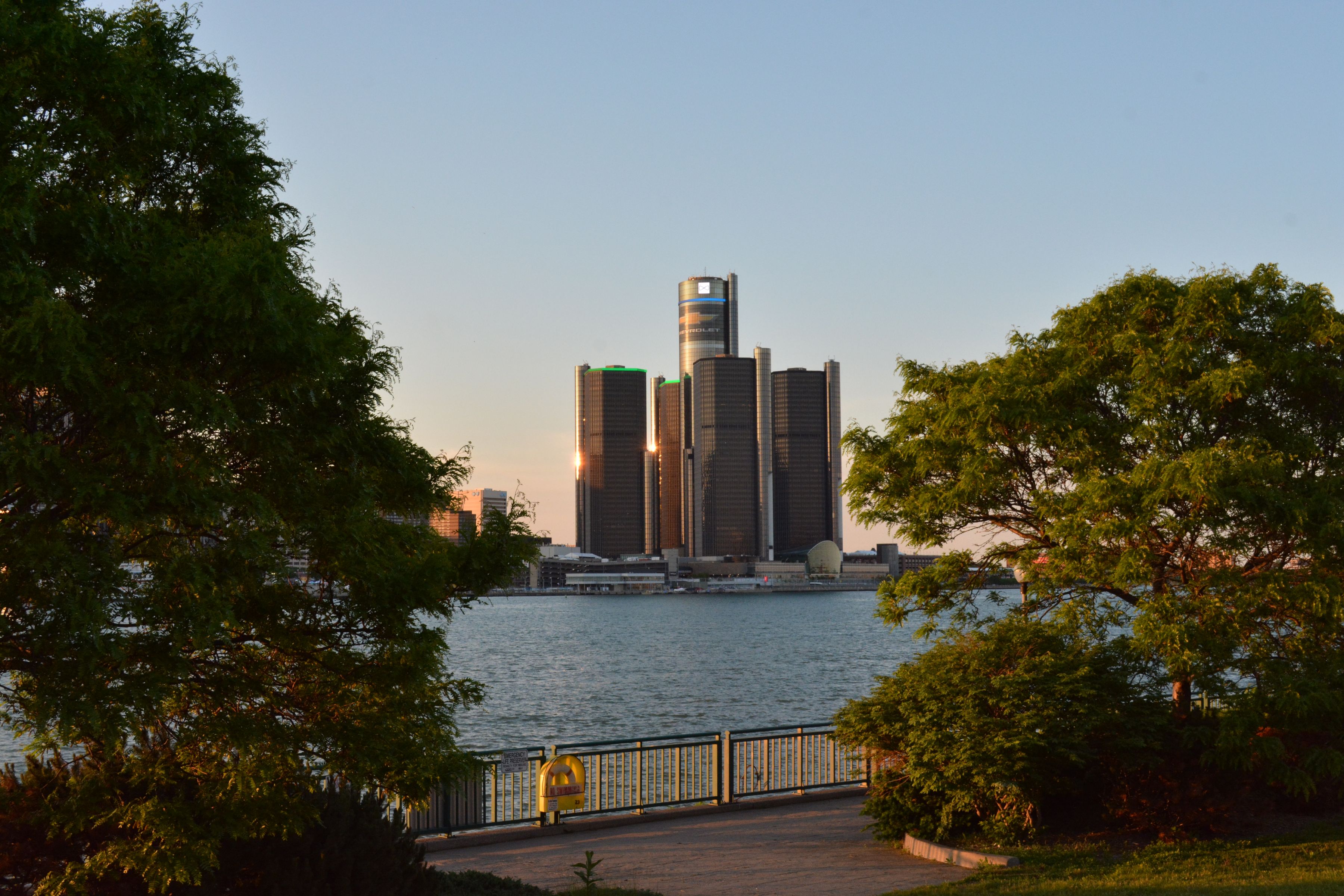 Detroit skyline and Renaissance Center towers at sunset over the river