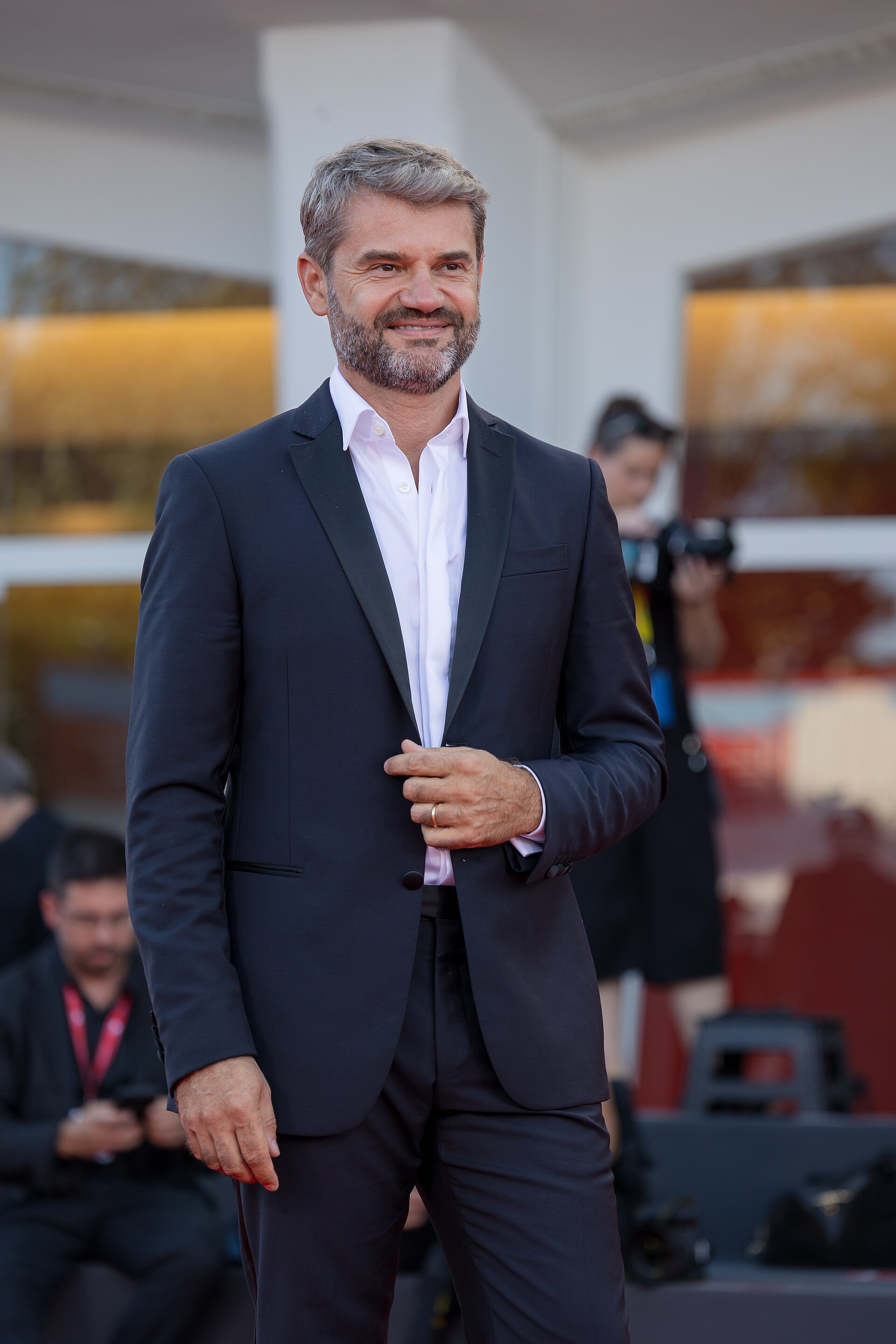 Chef Enrico Bartolini in a dark suit and white shirt at an evening event
