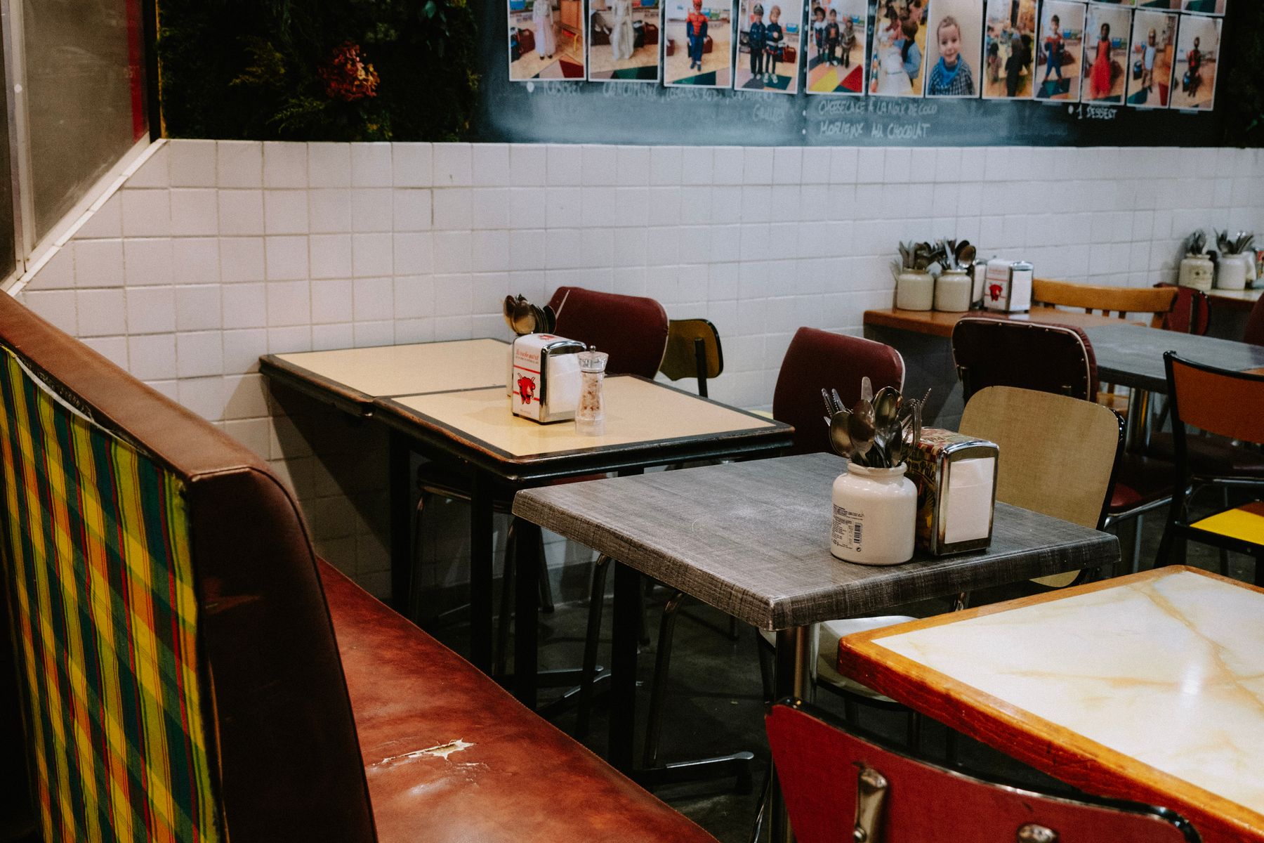 Empty diner booths with red vinyl seats in a shuttered American restaurant
