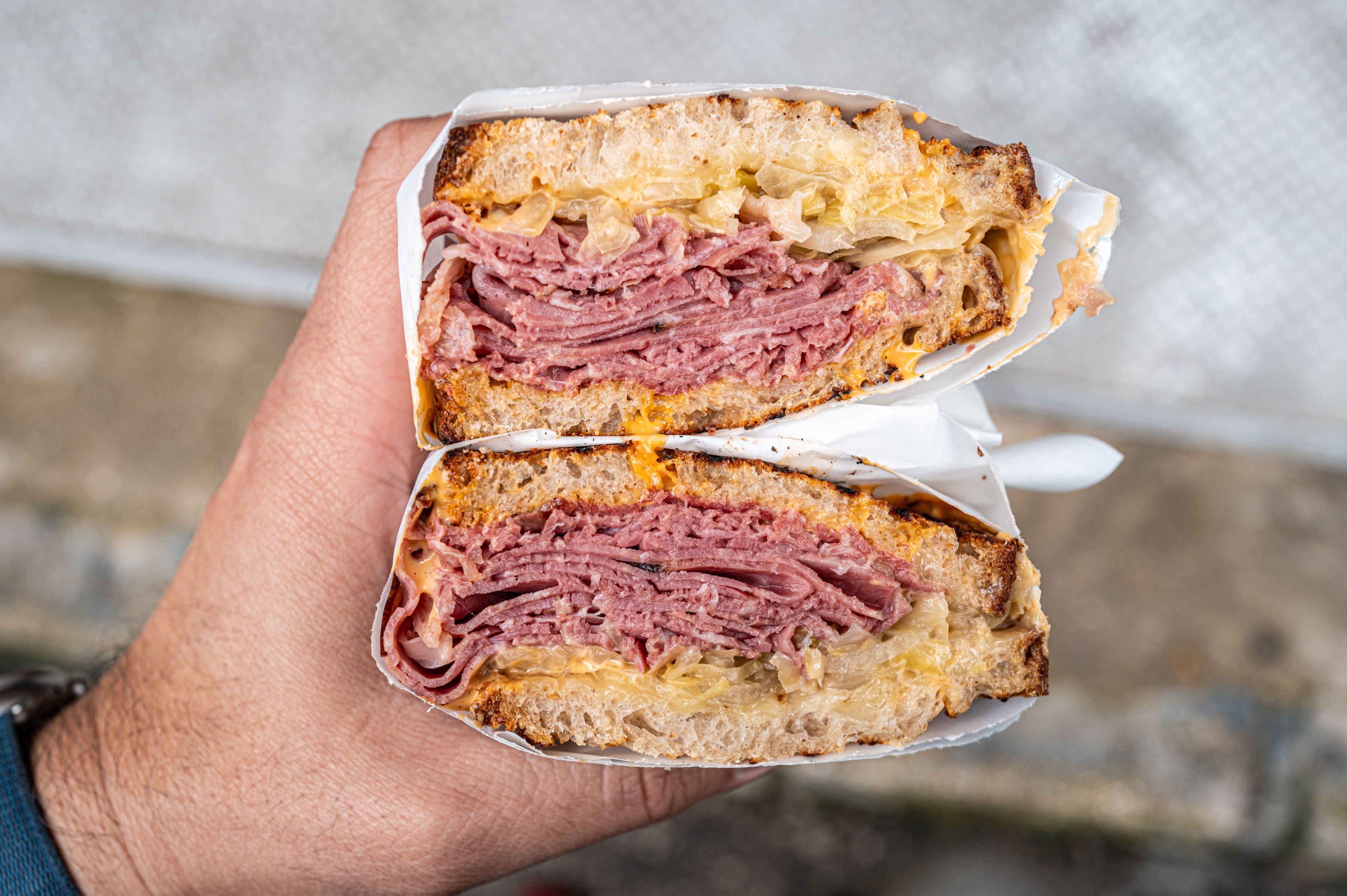 Close-up of a stacked pastrami sandwich on rye bread