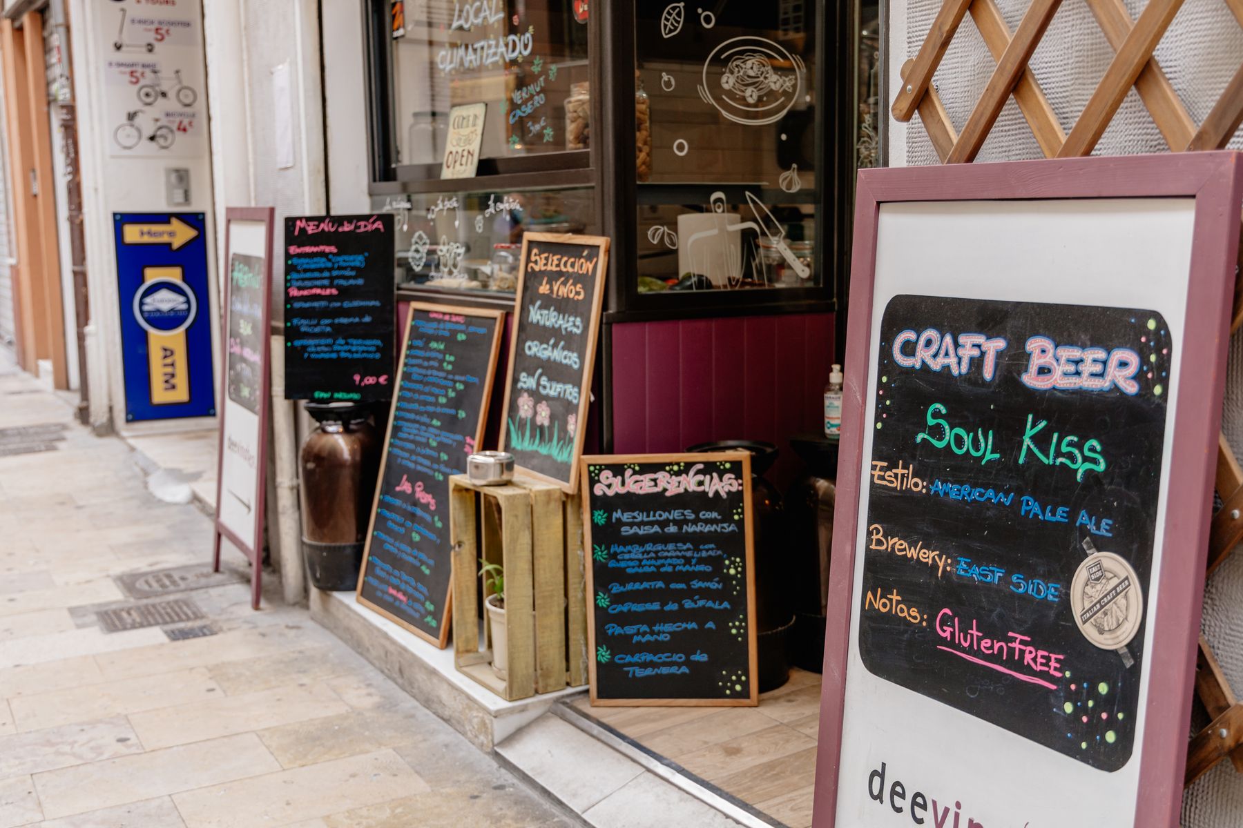 Chalkboard menus, including a menú del día, outside a café on a Valencia street