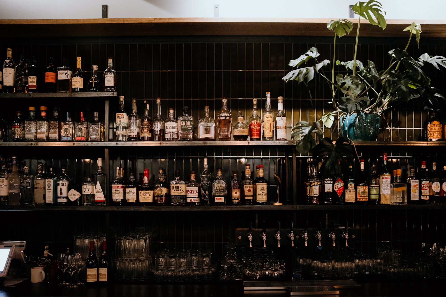 Back bar shelves lined with whisky, gin and liqueur bottles