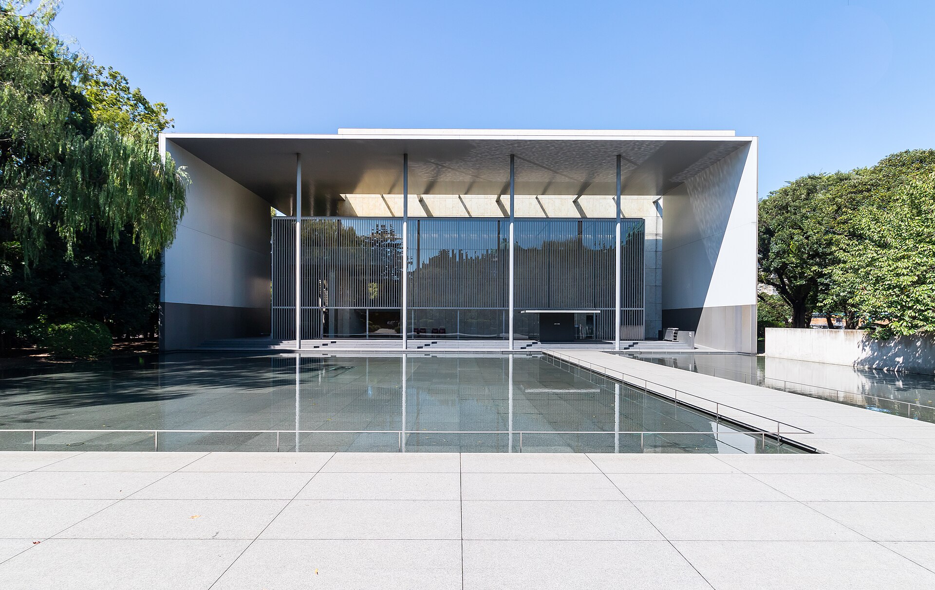 Glass facade of the Gallery of Horyuji Treasures behind a shallow reflecting pool in Ueno
