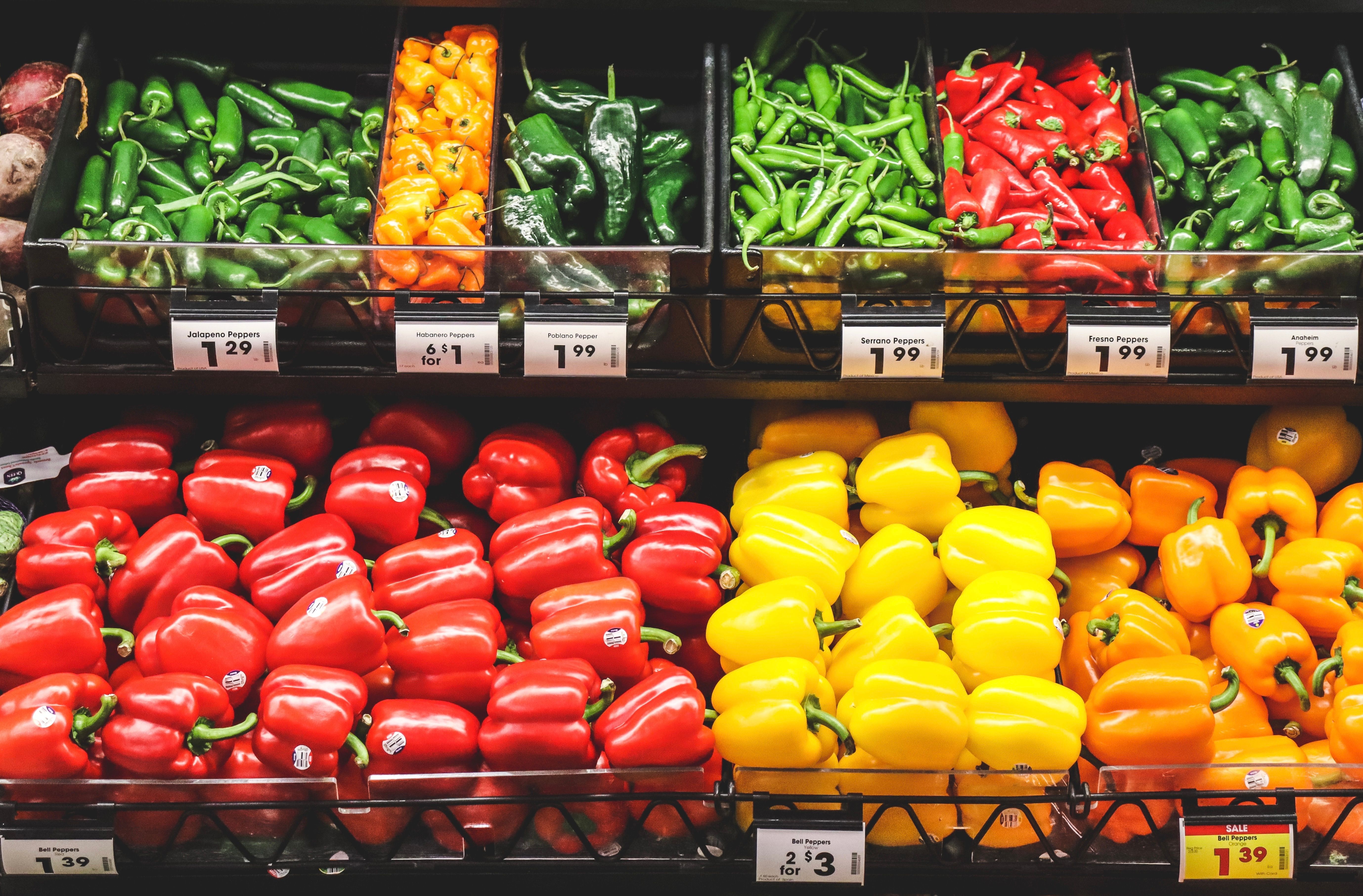 Peppers on supermarket shelves with visible dollar price tags