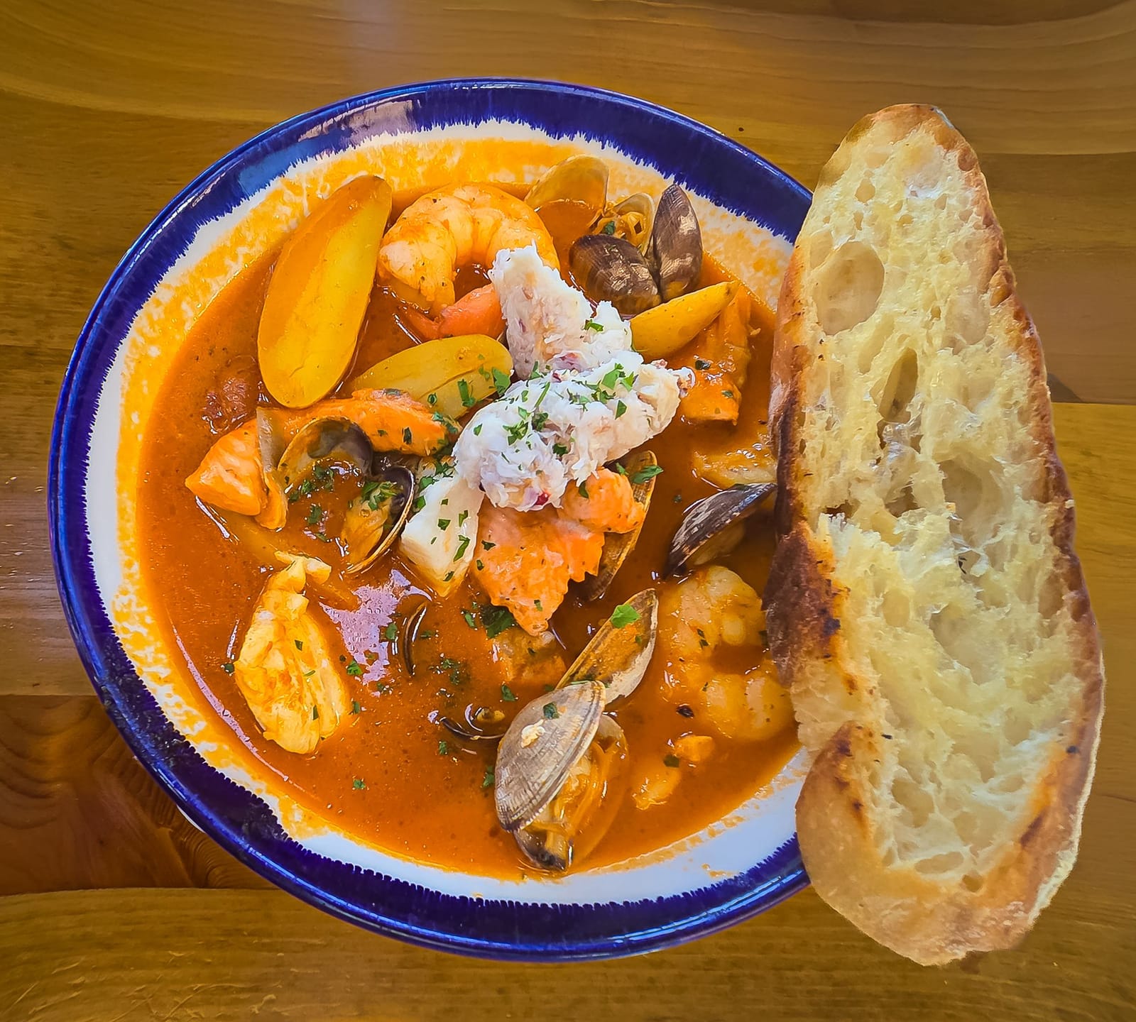 Bowl of bouillabaisse fish and shellfish stew with grilled bread