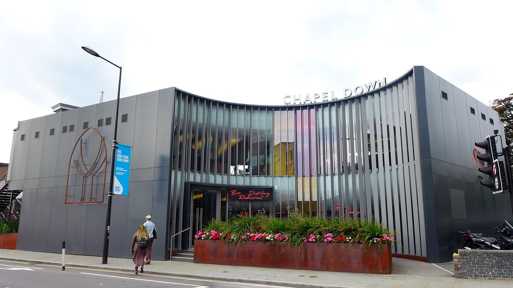 Chapel Down Bar, Distillery and Restaurant building at King's Cross with curved grey metal facade and planters