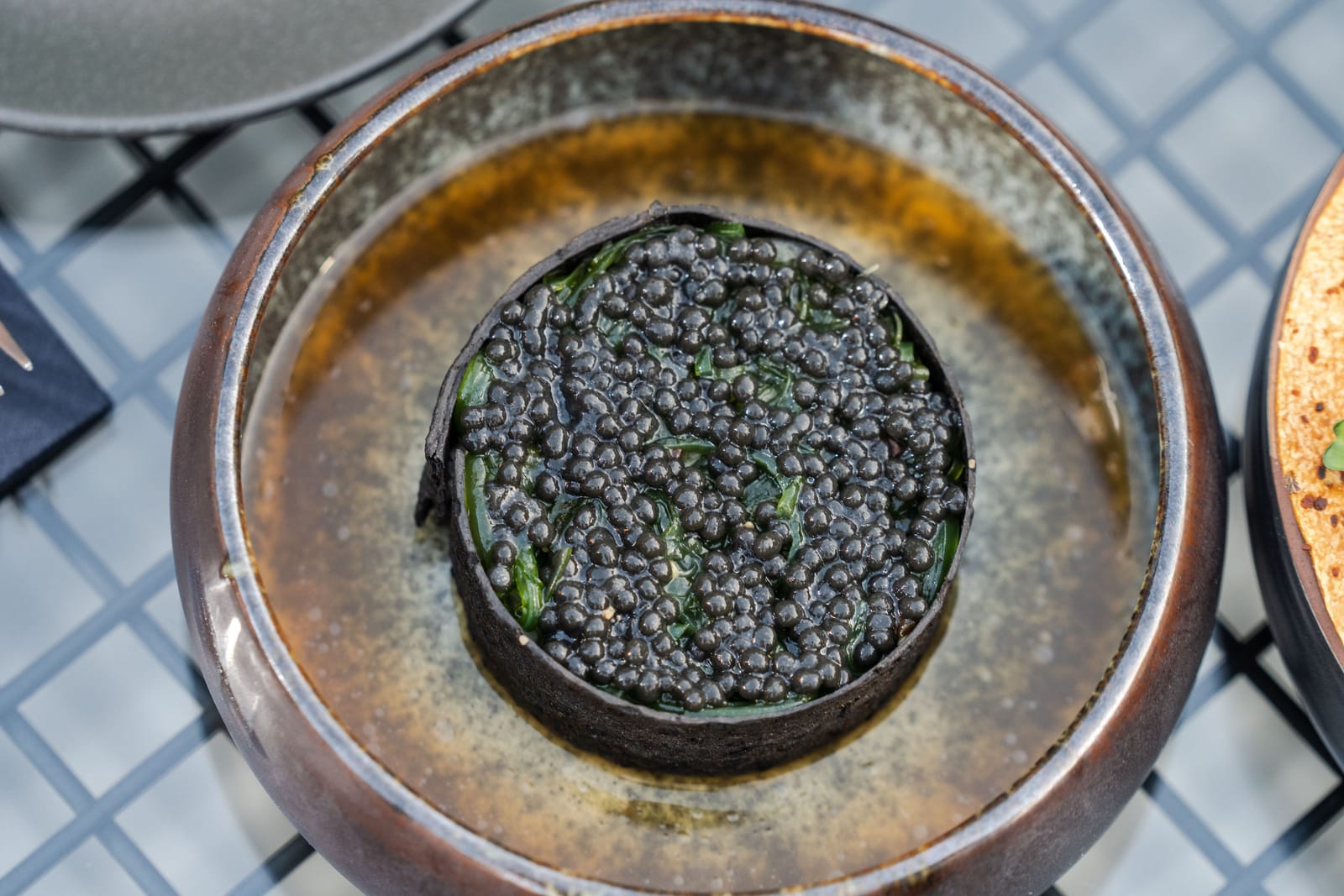 A close-up of black caviar roe glistening on a plate