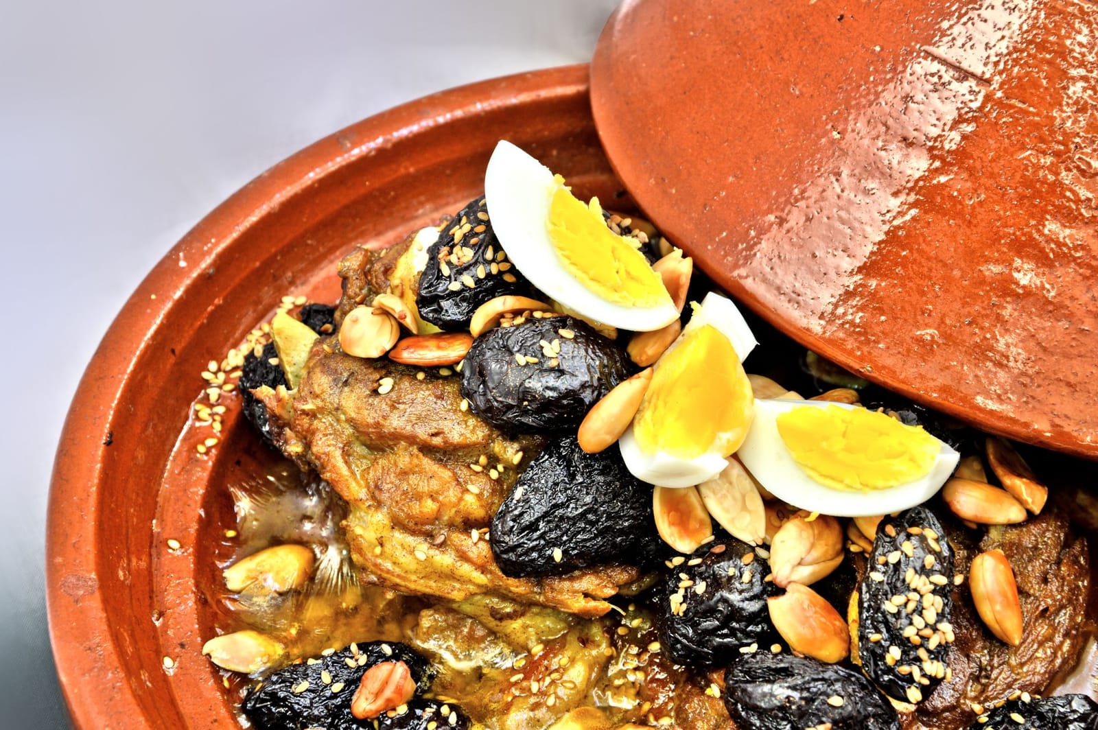 Clay tagine of braised lamb with dried fruit, almonds and boiled egg wedges