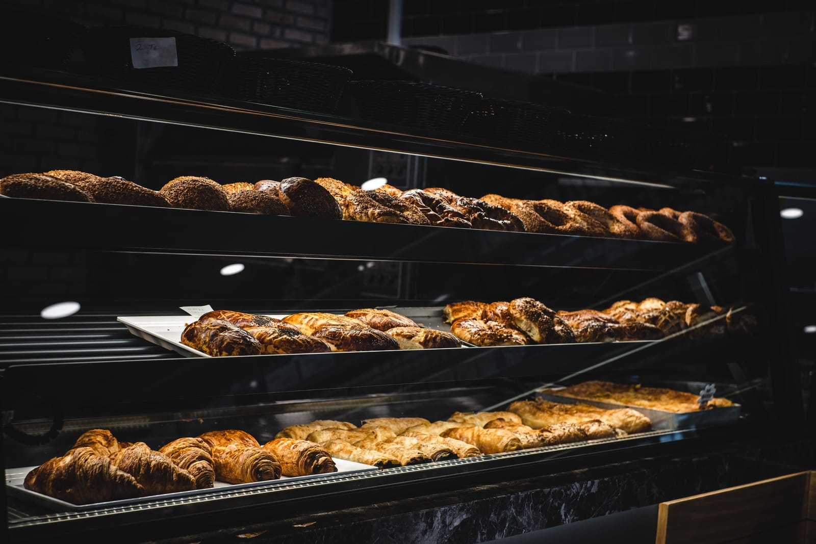Display of fresh pastries and baked goods in a bakery window