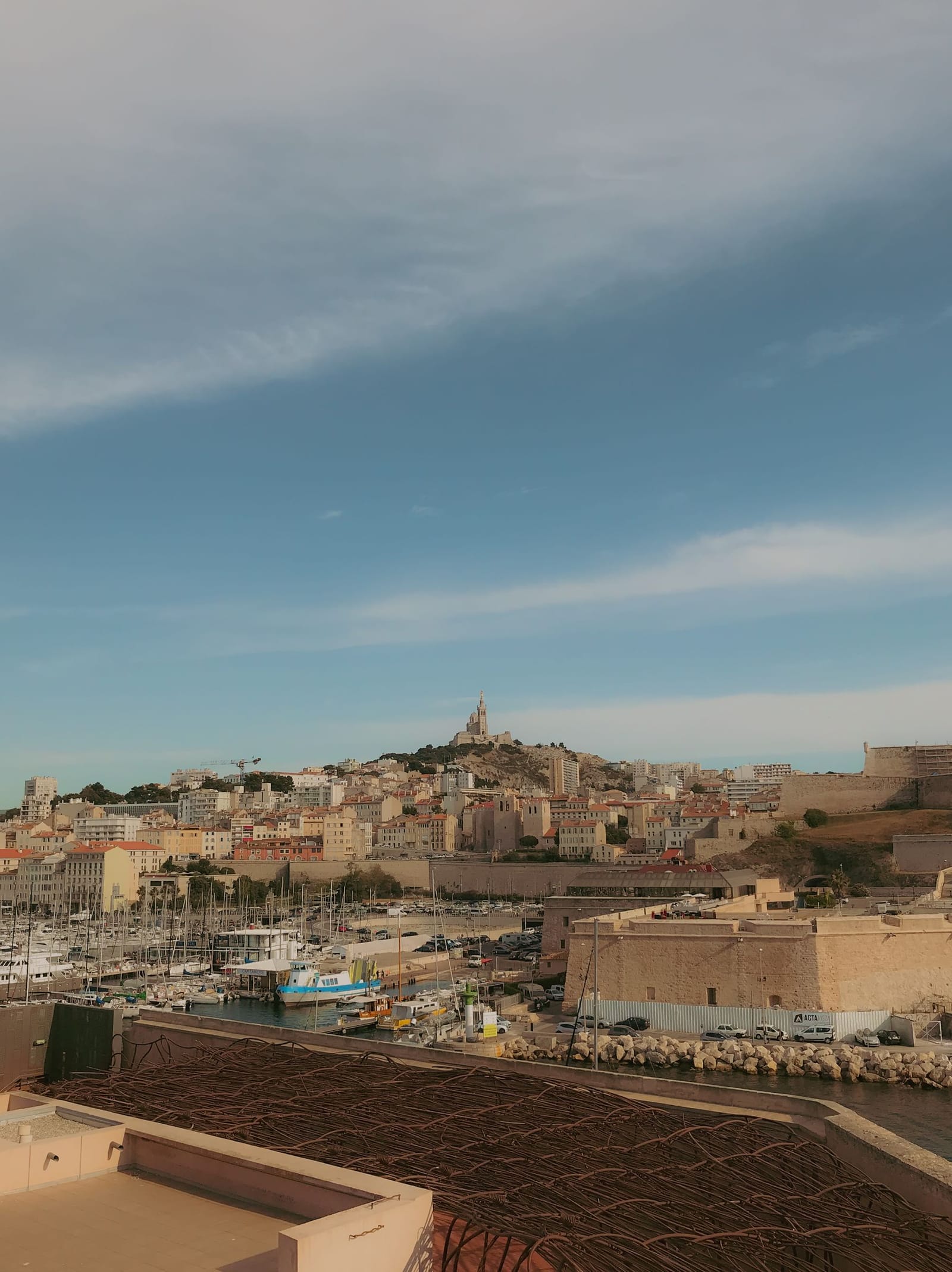 Panoramic view of Marseille's Vieux-Port with Notre-Dame de la Garde on the hill